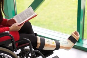 Picture of woman in wheelchair with leg cast