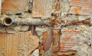 Picture of rusted pipe in brick wall