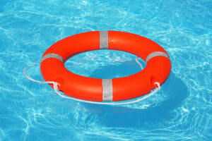 Orange lifebuoy in water