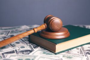 Gavel, law book, and money to show how a Houston car accident lawyer fights for your right to compensation